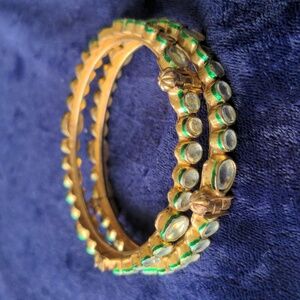 Two vintage gold tone bangle bracelets